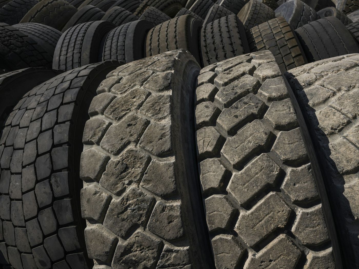 Used truck tyres stacked in a yard
